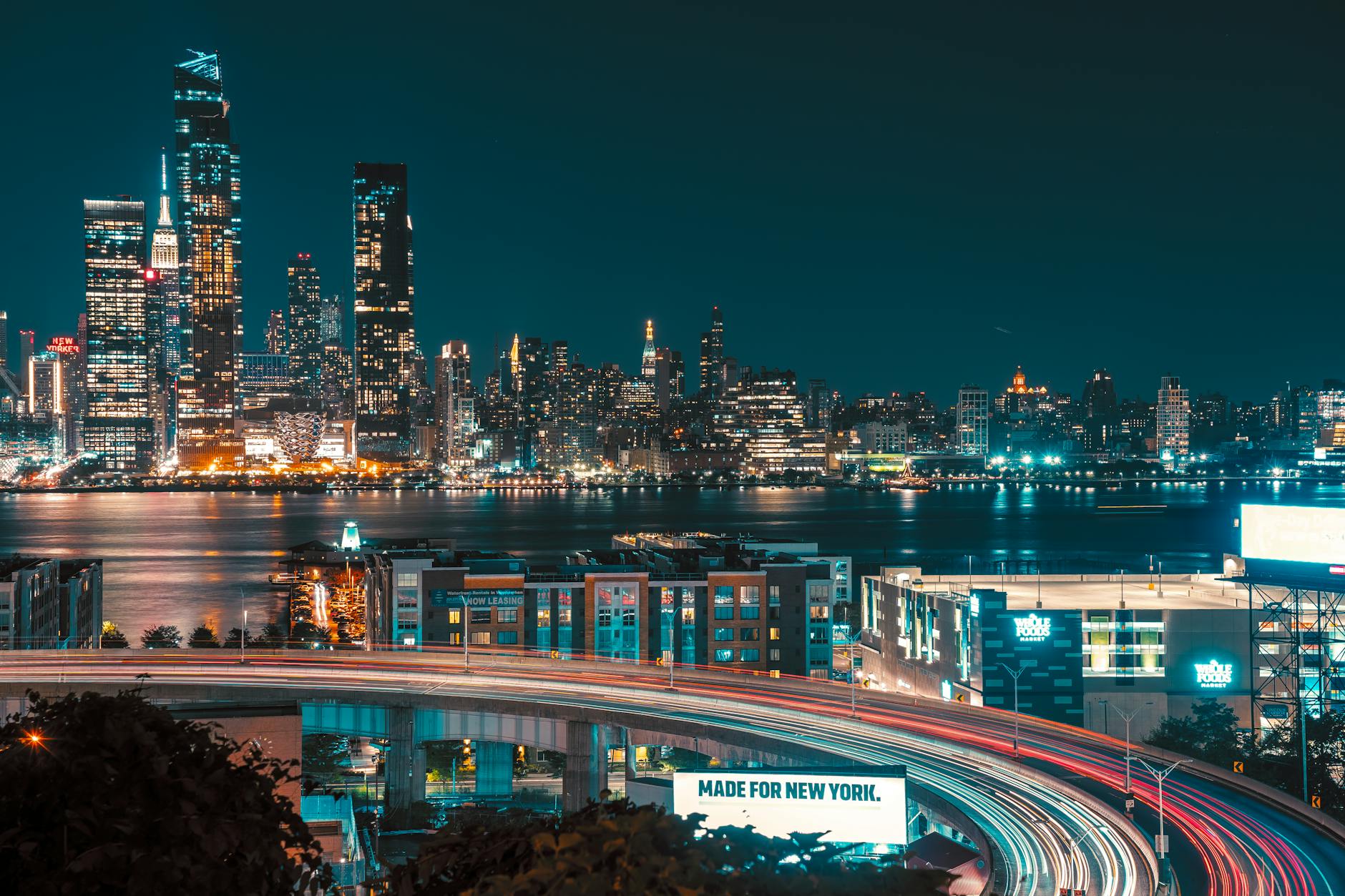 City skyline at night with office buildings lit up representing entrepreneurship
